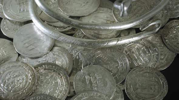 Ancient Viking Age Silver Coins and Bracelet on turntable