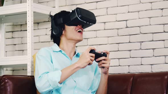 Asian man wearing virtual reality glasses experiencing innovative technology.