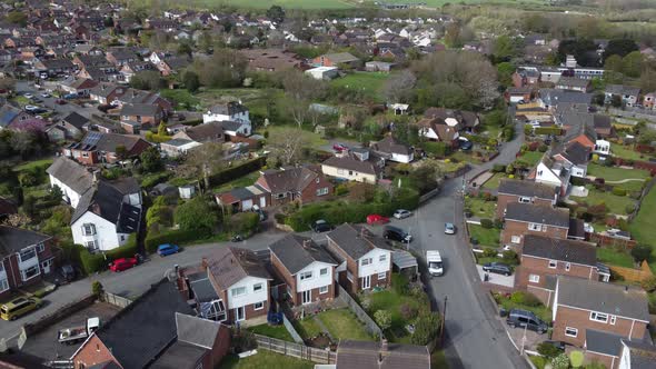 Aerial drone reveal shoting backwards over rural countryside houses, England
