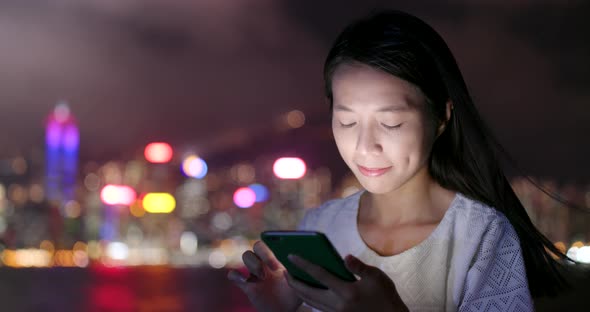 Young woman use of smart phone at night