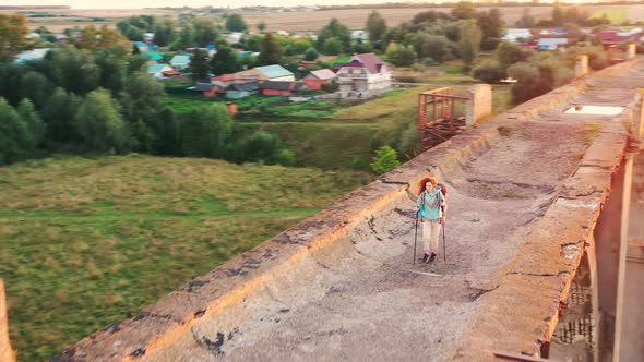 A Woman Is Having a Sports Walk Over a Desolated Bridge