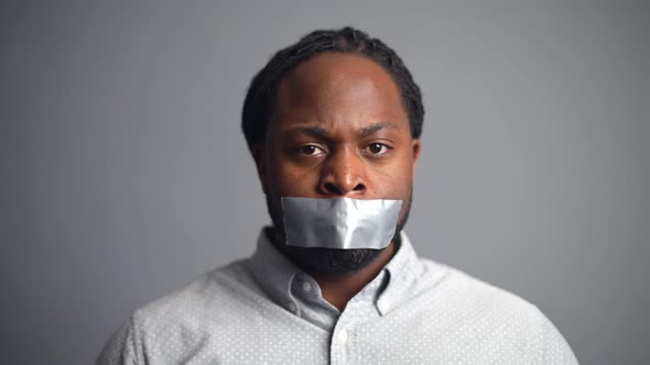 AfricanAmerican Guy Sealed Mouth Isolated on Grey Background