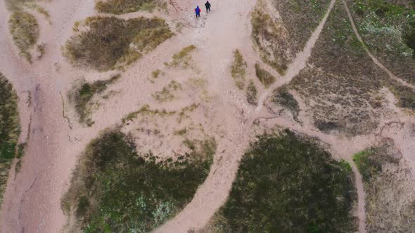 Aerial Of Tourists Walking on Grass Covered Sand Dunes