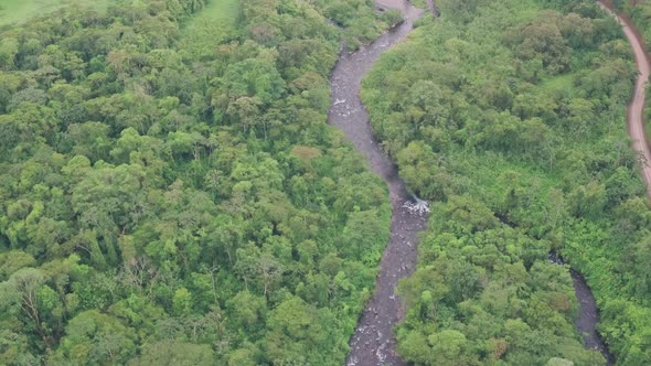 River through rainforest at Arenal Volcano National Park, Costa Rica. High aerial drone view