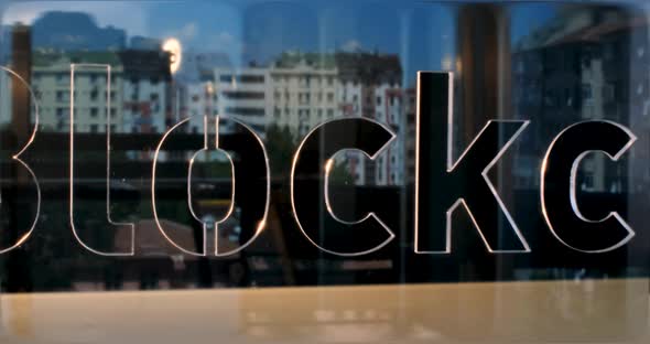 Glass Blockchain Letters and Office in Background