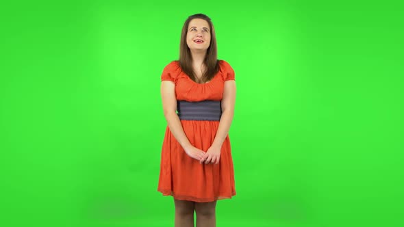 Cute Girl Is Daydreaming and Smiling Looking Up. Green Screen