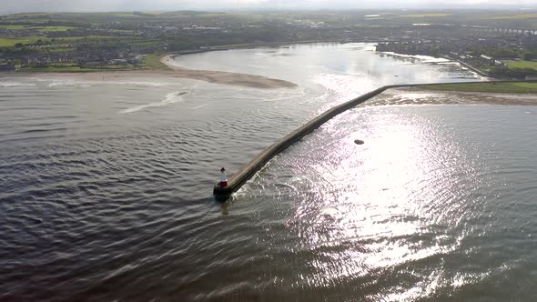 A Lighthouse and Breakwater at the Mouth of a Harbour in the UK