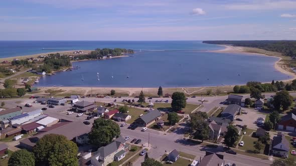 Aerial pan of houses and streets by bay in Grand Marais, Michigan