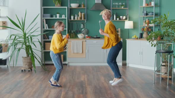 Cheerful Mom and Teenage Girl Jumping Fooling Around Having Fun Mental Health