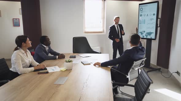 Business Meeting in Office, Young Businessman Speak at a Meeting and Shows Financial Infographic