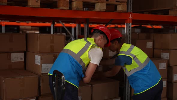Warehouse Workers Discussing Delivery During Walk