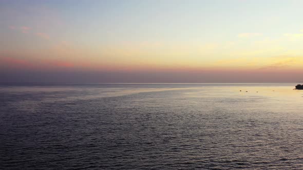 Dark sea surface after sun setting down the horizon and sky is coloring on purple, dusty sky in the