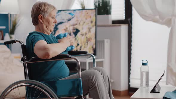 Old Woman with Disability Using Dumbbells to Exercise