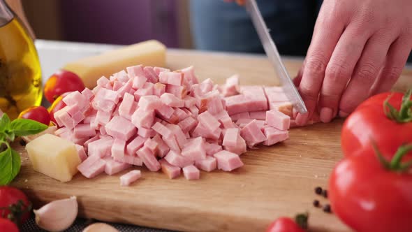 Making Pasta Carbonara Slicing Traditional Pancetta Bacon Into Pieces on a Wooden Cutting Board with