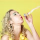 Young Woman in Party Hat Blowing Streamer - VideoHive Item for Sale