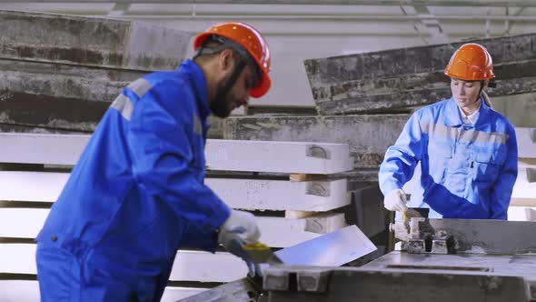 Workers doing finishing touches with concrete plate