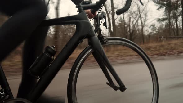 Cyclist Riding On Road Bike.Bike Wheels Rides Through Puddle. Cycling On Puddle And Splashing Water.