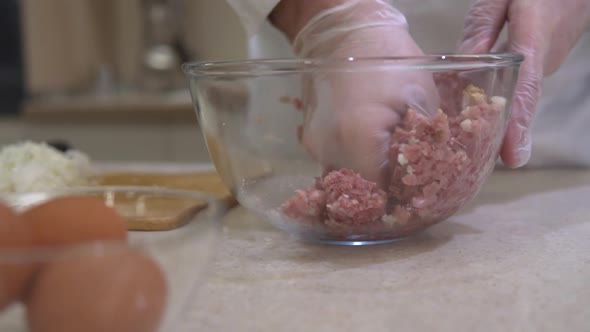 Beef ground meat making. Chef mixing fresh, raw minced meat for burgers