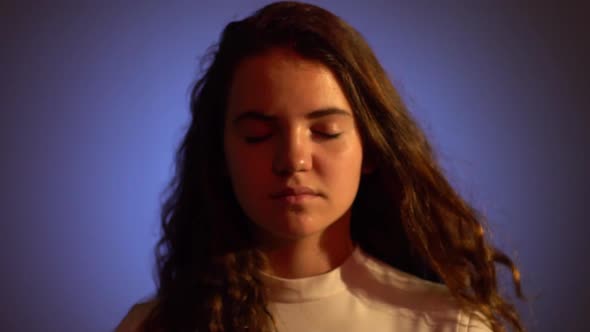 Portrait of Young Womans Eyes Opening Under Neon Light