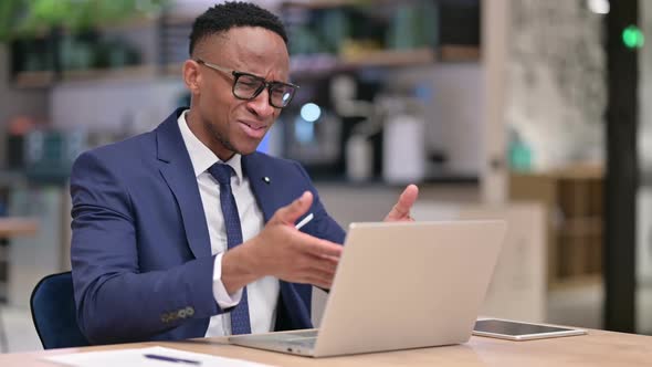 Loss African Businessman Reacting to Failure on Laptop in Office