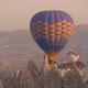 Various Hot Air Balloons of Different Colours Fly Over Cliff - VideoHive Item for Sale