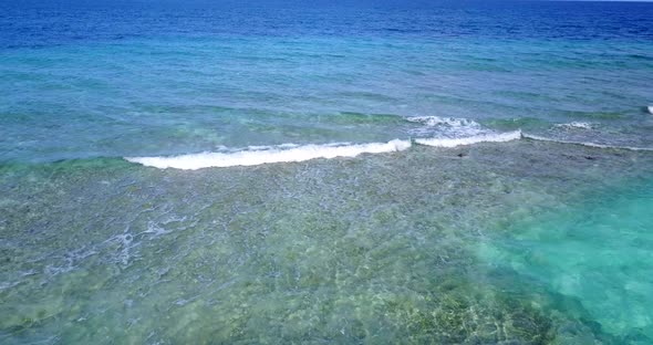 Wide angle above abstract shot of a sunshine white sandy paradise beach and aqua blue water background