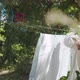 Beautiful Young Female Hanging Up Clean Wet Laundry On Clothesline in Countryside - VideoHive Item for Sale