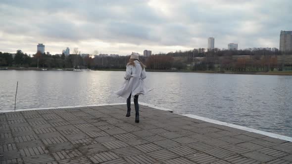 A Girl Runs Along the Embankment