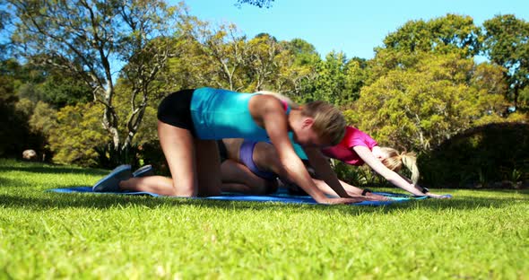 Young women exercising in park