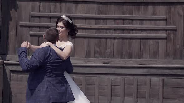 Slow Motion Man Raises Bride in Wedding Dress with Veil