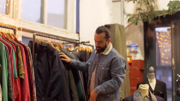 Man Choosing Clothes at Vintage Clothing Store 4