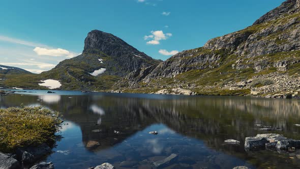 Peaceful Scenery At The Lake With Mountain Reflections Under A Blue Cloudy Sky In Storehorn, Hemseda