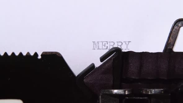 Man Is Typing a Letter on the Typewriter of a Merry Christmas. Close Up