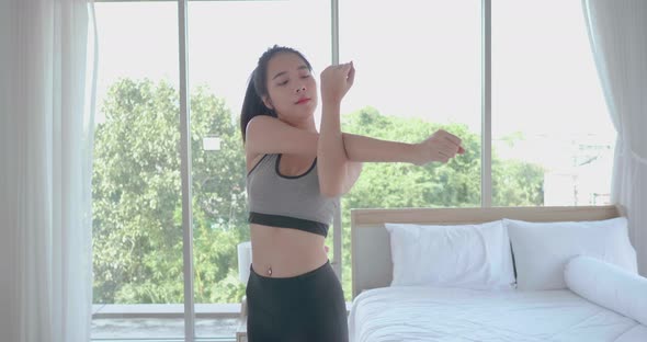 Asian woman stretching muscle to warm up before start workout