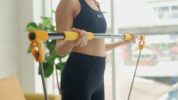 Healthy beautiful Asian woman standing exercise in the living room at home