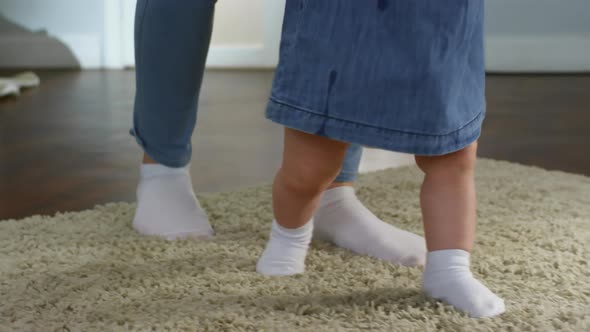 Baby Girl Walking with Mother’s Support