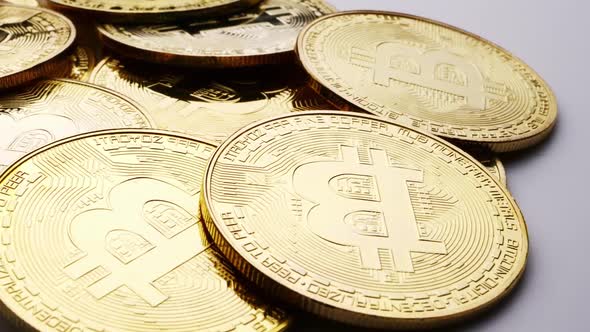 Close up of golden coins with bitcoin symbol background.