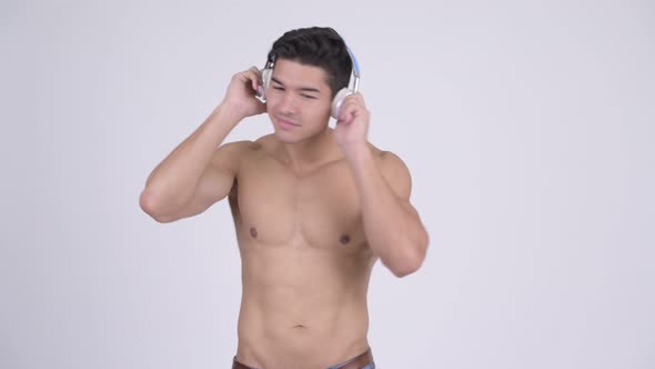 Young Handsome Muscular Shirtless Man Listening To Music