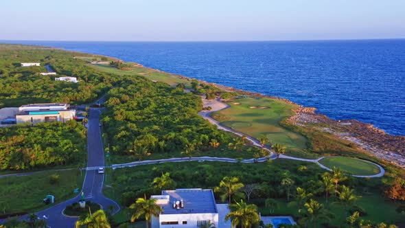 Aerial sideways over seafront golf course of Playa Nueva Romana in Dominican Republic