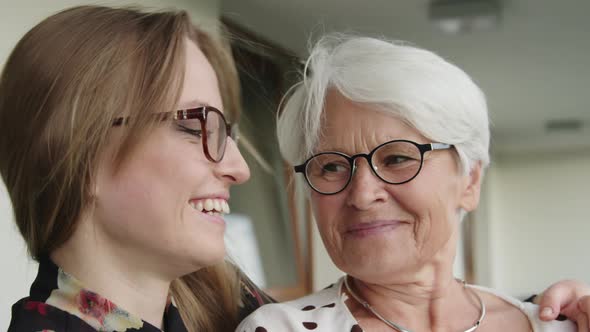 Head Shot of Happy Young and Senior Woman Hugging Each Other. Family Reunion