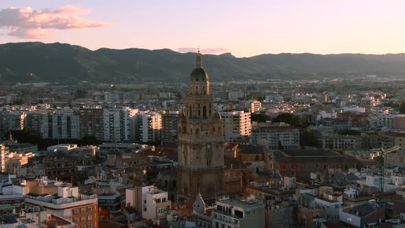 Drone shot of Murcia Cathedral and city skyline in Spain at sunset