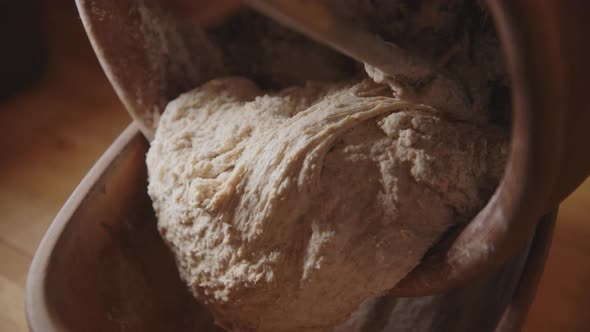 BAKING - Pouring sourdough bread dough to baking dish, slow motion tilt down