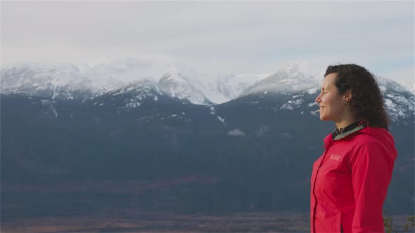 Adventurous Girl Hiking in the Mountains During a Sunny Winter Sunset