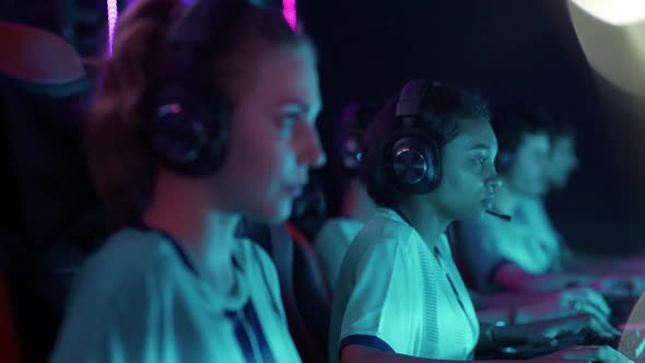 Female Gamers in Headphones Plays a Video Game Cyber Sportsmans at the Game Communication Between