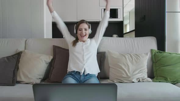 Happy Young Business Woman Enjoy Success Looks At Laptop At Home Office.