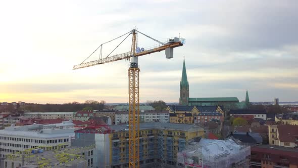 Aerial view of construction site of new residential building wint tower crane.