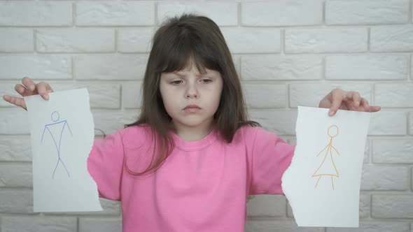 Divorce. A child with a drawing of parents. 