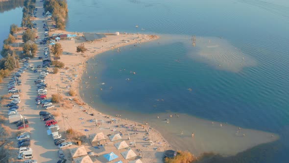 Plenty of Holidaymakers People on the Beach in Blue Azure Lagoon Aerial View