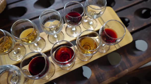 Samples of White Pink and Red Wine in Glasses on a Wooden Tray