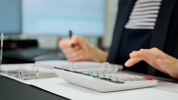 Close Up Footage of Woman Accountant Working Using Calculator